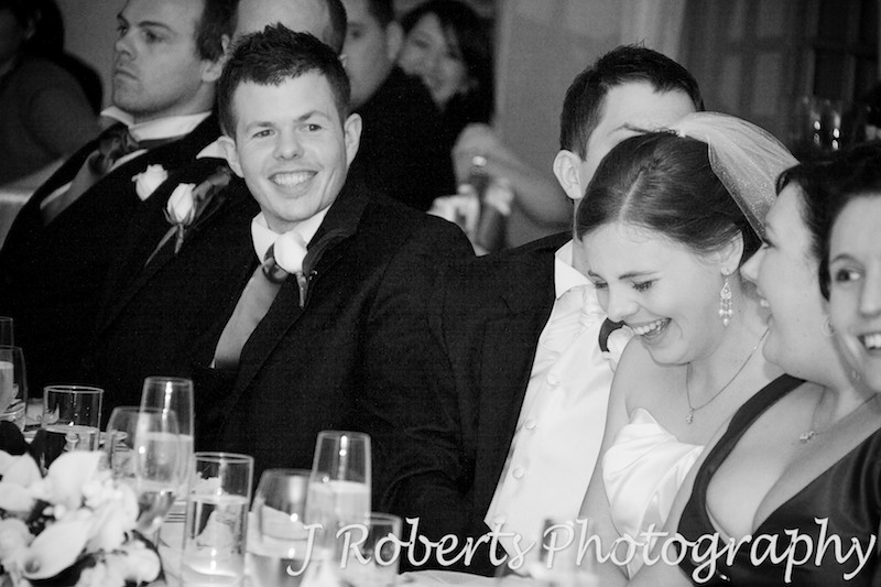 Bridal party laughing during reception speeches - wedding photography sydney